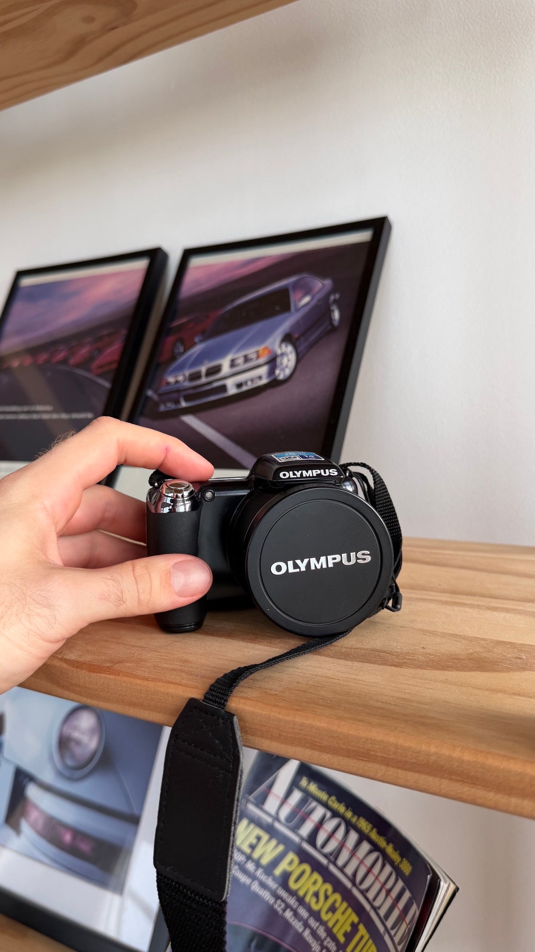 Olympus SP-810UZ in hand with Olympus lens cap